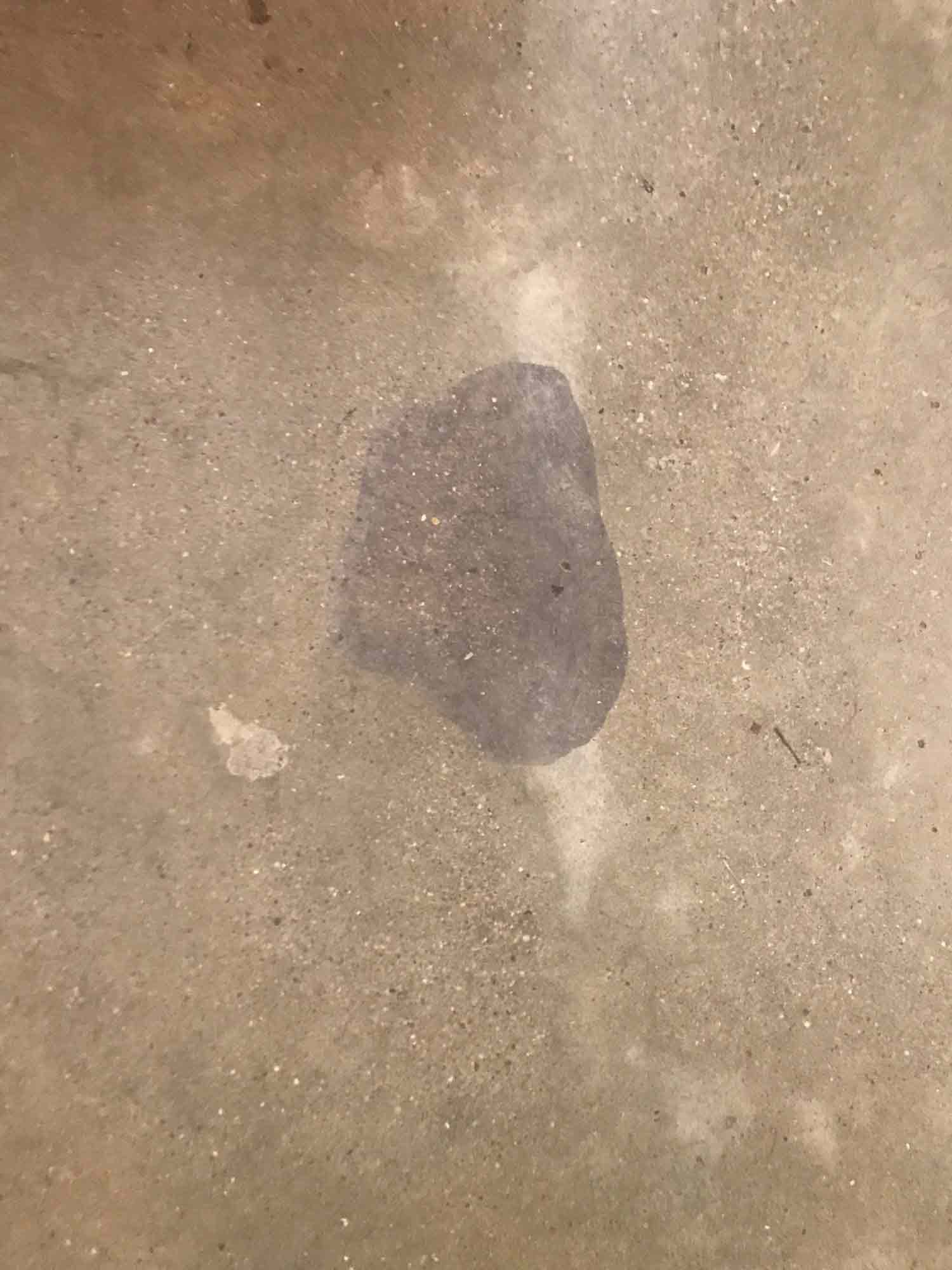 A red wine stain on a polished concrete floor.