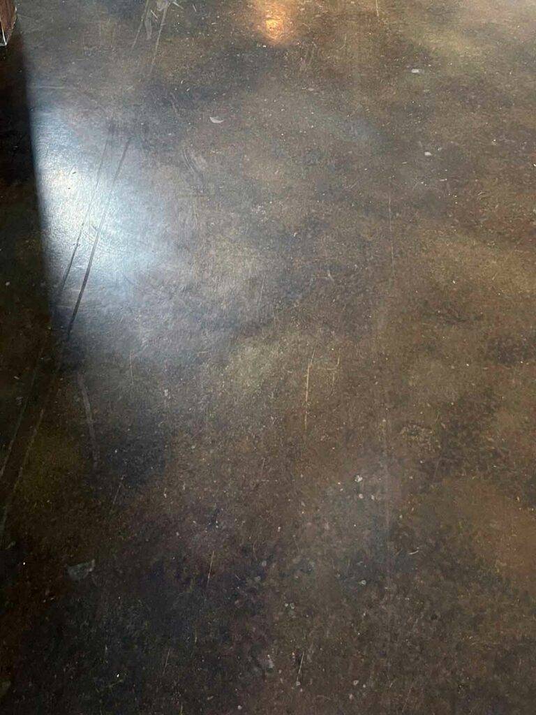 A heavily scratched ‘stained and sealed’ concrete floor. These scratches required repairs to the entire home to resolve. 